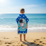 Back view of a blue star print poncho towel with a helmeted astronaut floating in space