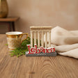 Standing souvenir with the Baalbeck temple columns in cream stone behind a red Lebanon