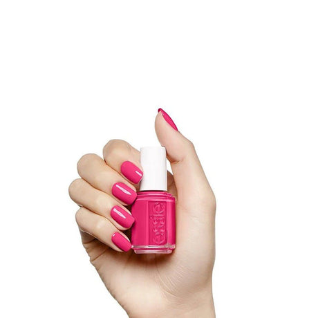Hand with magenta pink manicure holding the Bachelorette Bash polish bottle