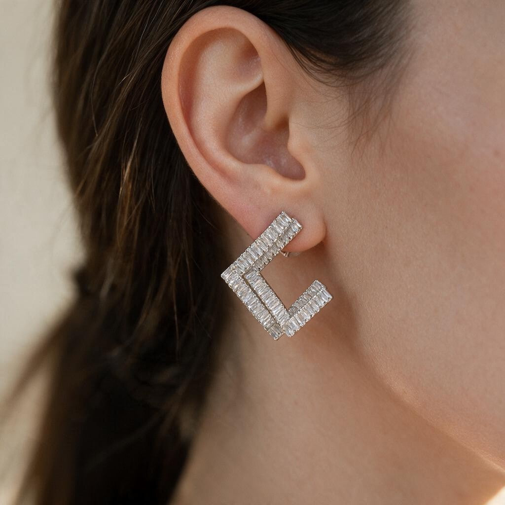 Clear baguette crystal open square earring in silver tone worn on the ear