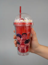 Red basketball cup held in a hand showing the mini striped ball inside the dome