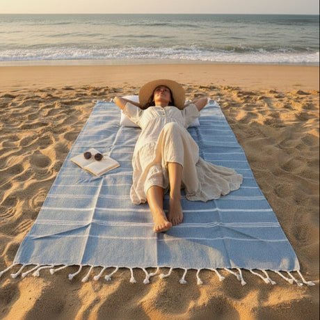 Woman lying on a blue towel at the beach with 'Beach Mode' text.