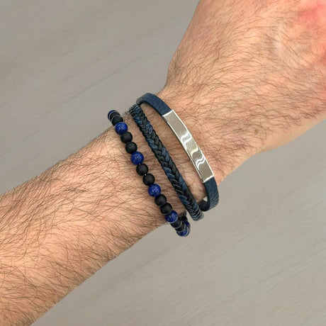 Navy leather and blue lapis bead bracelet stack with a silver bar on a wrist