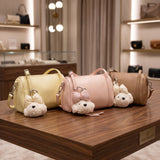 Pastel yellow, pink and camel barrel crossbody bags with fluffy teddy bear charms