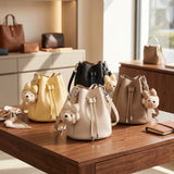 Yellow, black, cream and taupe drawstring bucket bags with bear charms
