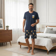 Man wearing a navy beer print pyjama set with matching shorts