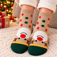 Beige Christmas socks with red stars, green dots, a red nosed reindeer face and dark green toes