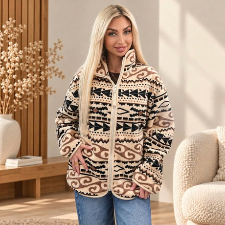Woman in a beige fleece zip jacket with a black and brown aztec pattern and high stand collar