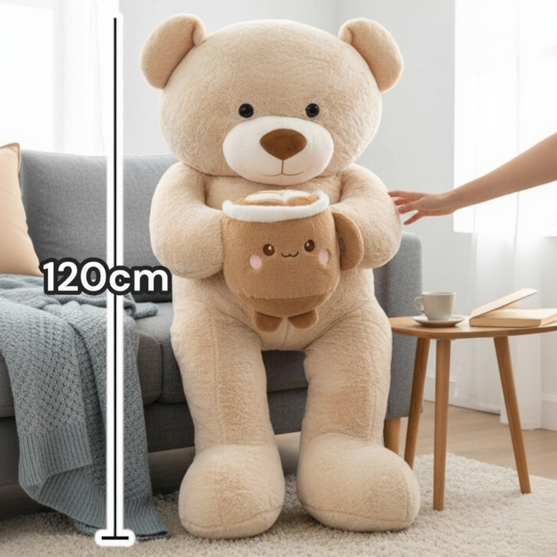 Beige teddy bear seated against a sofa with the latte cup plush and a 120cm line
