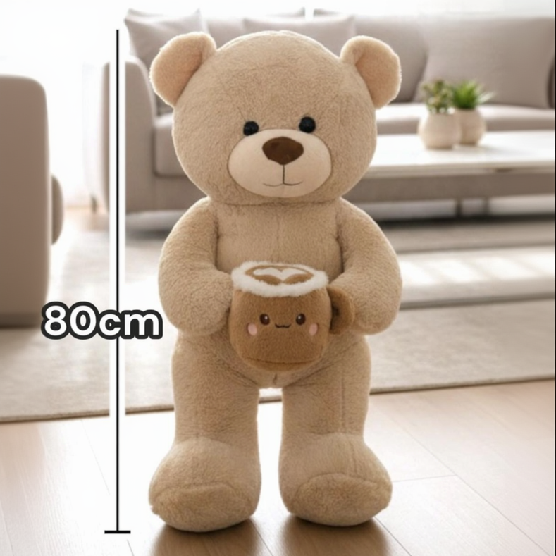Beige smooth pile teddy bear with a latte mug plush, a heart drawn in its foam