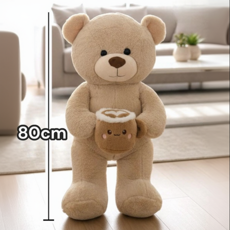 Beige smooth pile teddy bear with a latte mug plush, a heart drawn in its foam