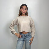 Oatmeal chunky knit crop sweater with long sleeves, worn with low rise jeans