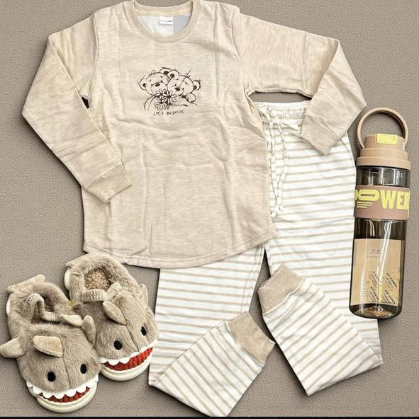 Beige teddy print pajama set flat lay with striped pants and shark slippers