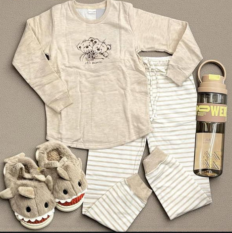 Beige teddy print pajama set flat lay with striped pants and shark slippers