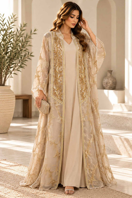 Woman in a beige two piece abaya with a sheer gold embroidered open robe over a maxi dress