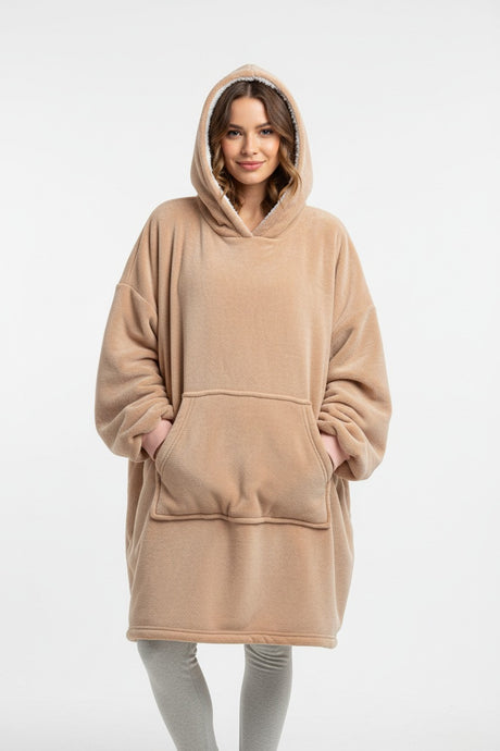 Woman wearing a beige hooded blanket with a white backound