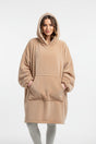 Woman wearing a beige hooded blanket with a white backound