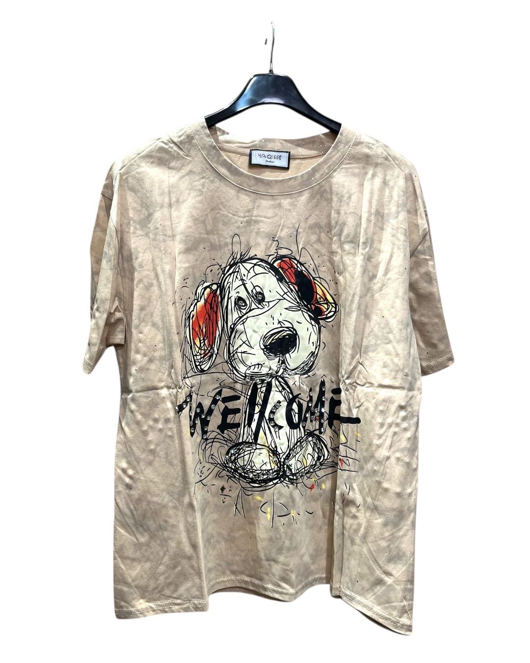 Oversized beige tshirt with dog graphic and 'WELCOME' text on a hanger