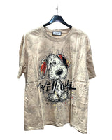 Oversized beige tshirt with dog graphic and 'WELCOME' text on a hanger