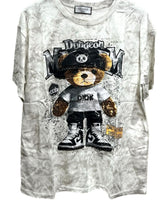 Oversized beige tie-dye tshirt with a graphic of a bear wearing a hat and lettering, and splatter details