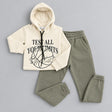 Cream hoodie with Test All Your Limits print laid out with army green joggers