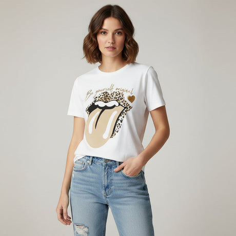 Woman wearing a white tshirt with a graphic tongue design and light blue jeans on a plain background