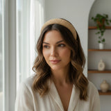 Beige woven headband worn with soft waves, styled indoors by a bright window