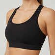 Black sports bra worn by a person on a plain background