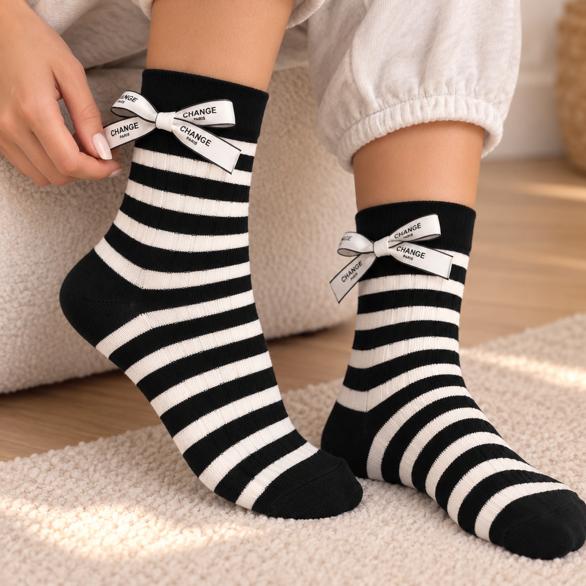 Black and white stripe ribbed socks with a printed satin bow at each cuff