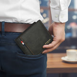 Black canvas bifold wallet tucked into a back trouser pocket