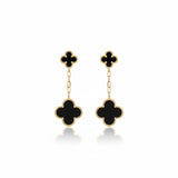Black clover-shaped earrings on a white background