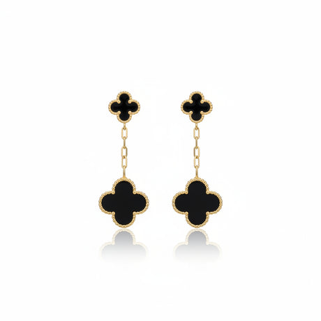 Black clover-shaped earrings on a white background