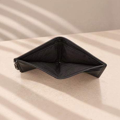 Open note compartment of the black compact wallet with its fabric lining visible