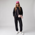 Women's black crewneck sweatshirt and cuffed jogger sweatpants set, full length front view