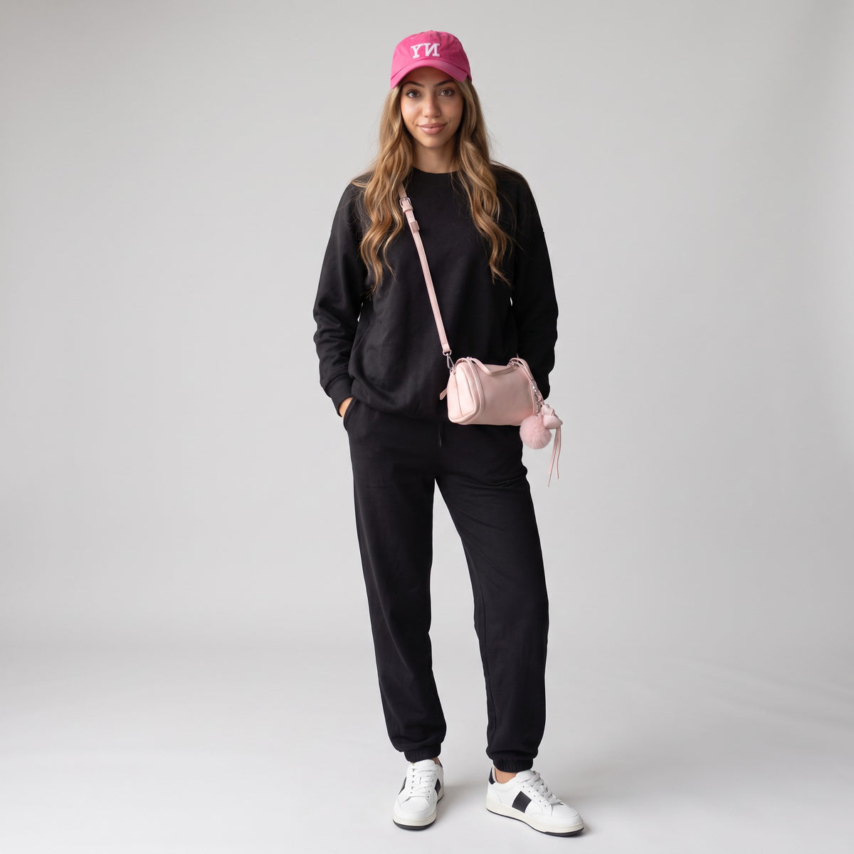 Women's black crewneck sweatshirt and cuffed jogger sweatpants set, full length front view