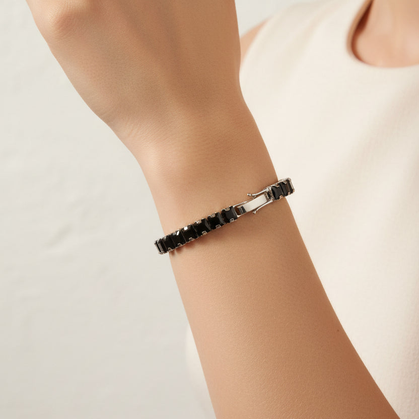 Black square bracelet with stones on a person's wrist