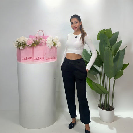 Women's black cuffed sweatpants worn front on with both hands in the side pockets