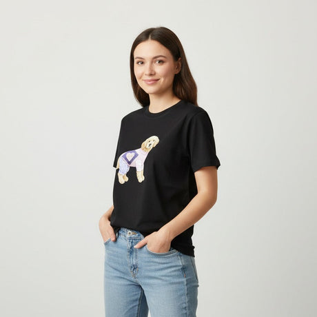 Woman wearing a black tshirt with a graphic design on a plain background
