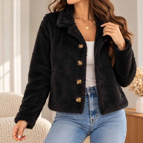 Black faux fur jacket with a wide collar and four bronze buttons, worn open over a white tank and jeans