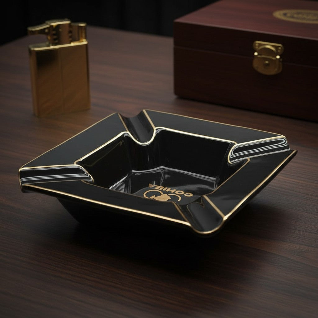 Side angle of the black ceramic ashtray showing its grooved rests and gold rim lines