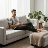 Black heather pyjama set worn relaxing on a sofa with feet up