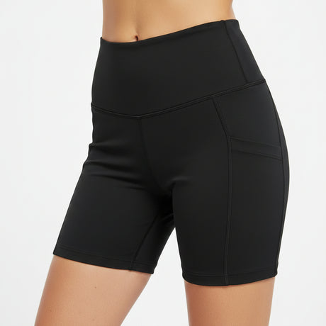 Woman wearing black athletic biker shorts against a white background
