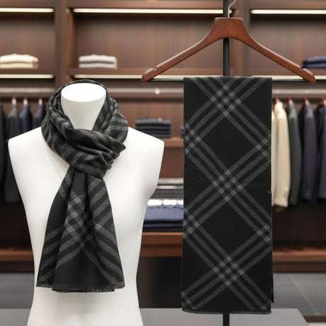 Black and grey plaid scarf on a mannequin and hanger against a clothing store background