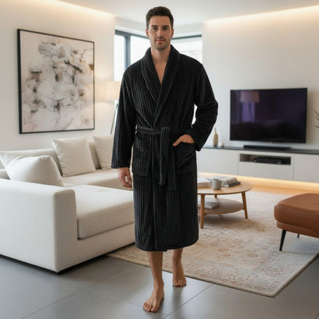 Man wearing a black ribbed bathrobe in a modern living room