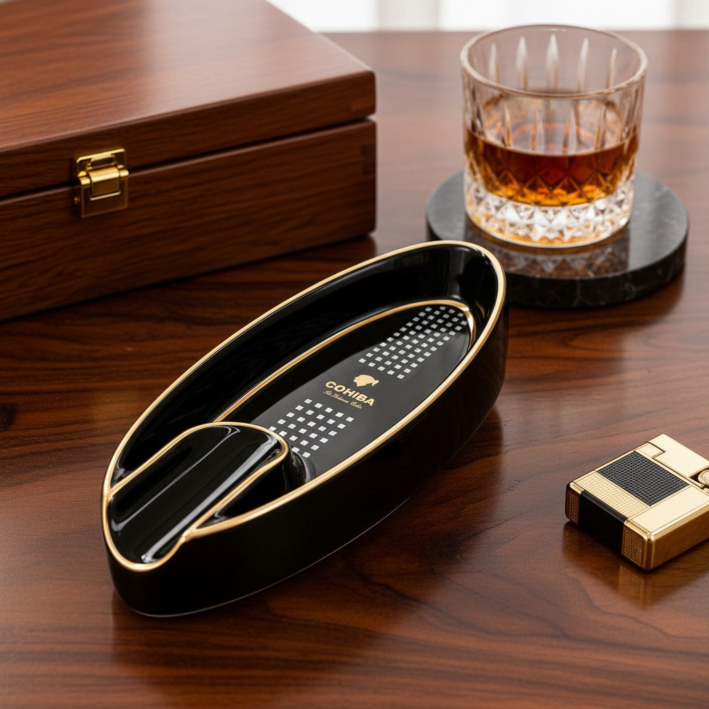 Wooden table setting with the black oval tray, a closed cigar box and a gold lighter