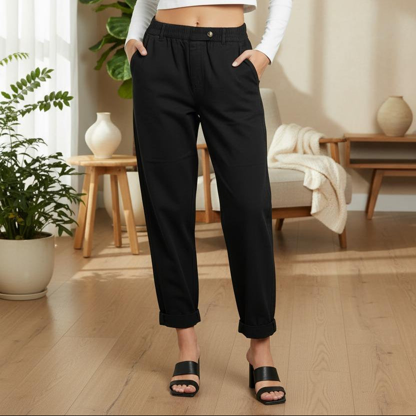 Person wearing black pants in a living room setting