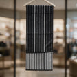 Black scarf with thin grey vertical stripes folded over a hanger, showing a grey striped reverse