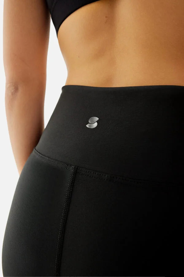Black athletic leggings with a brand logo on a white background