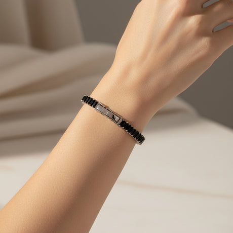 Black baguette tennis bracelet on a person's hand