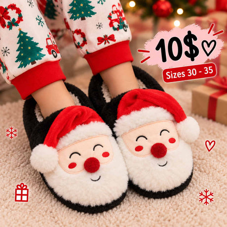 Kids black fluffy slippers with a white Santa beard, red pom pom nose and red hat on a cream rug